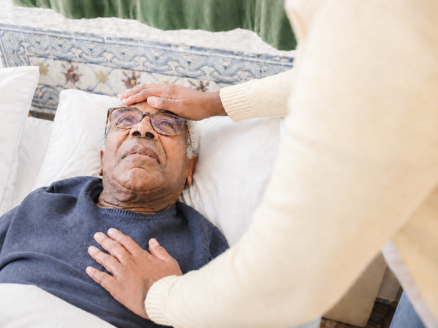 A trained carer providing close support to an older adult with higher dependency needs at home
