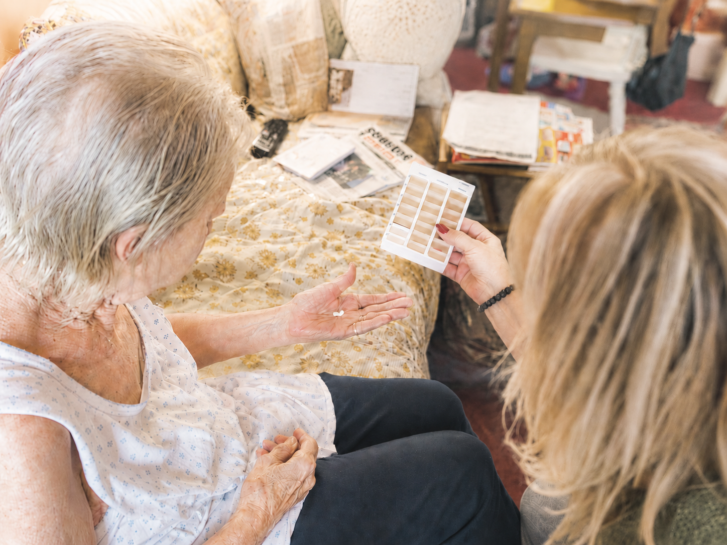 A trained care worker supporting safe medication prompting during a home visit