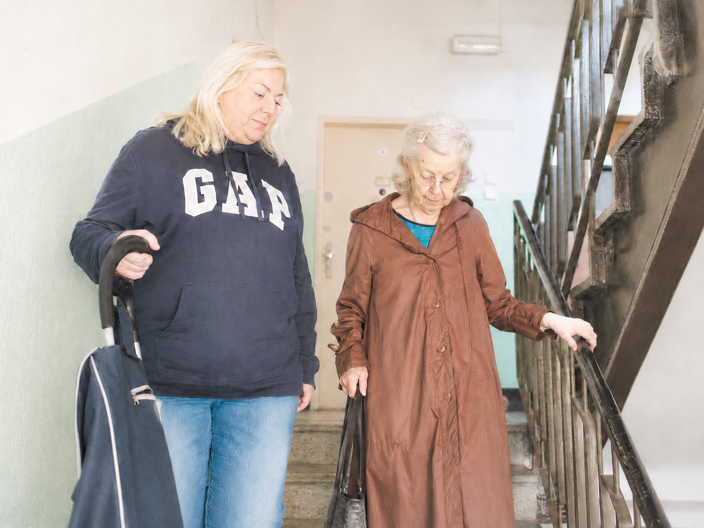 A care worker supporting safe mobility while family carers take restorative respite